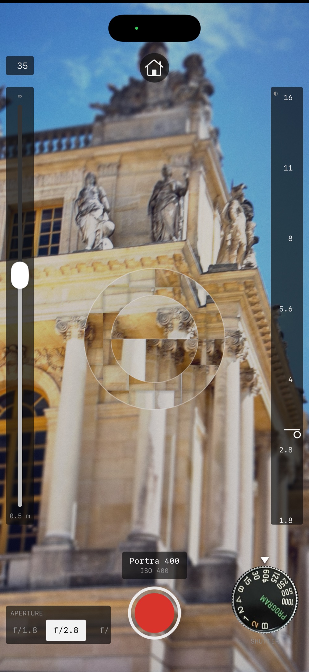 The viewfinder: focus slider on the left, light meter on the right, aperture bar and shutter dial below, microprism ring in the centre